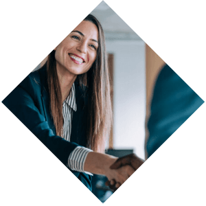 Smiling business professional woman who is shaking hands with someone